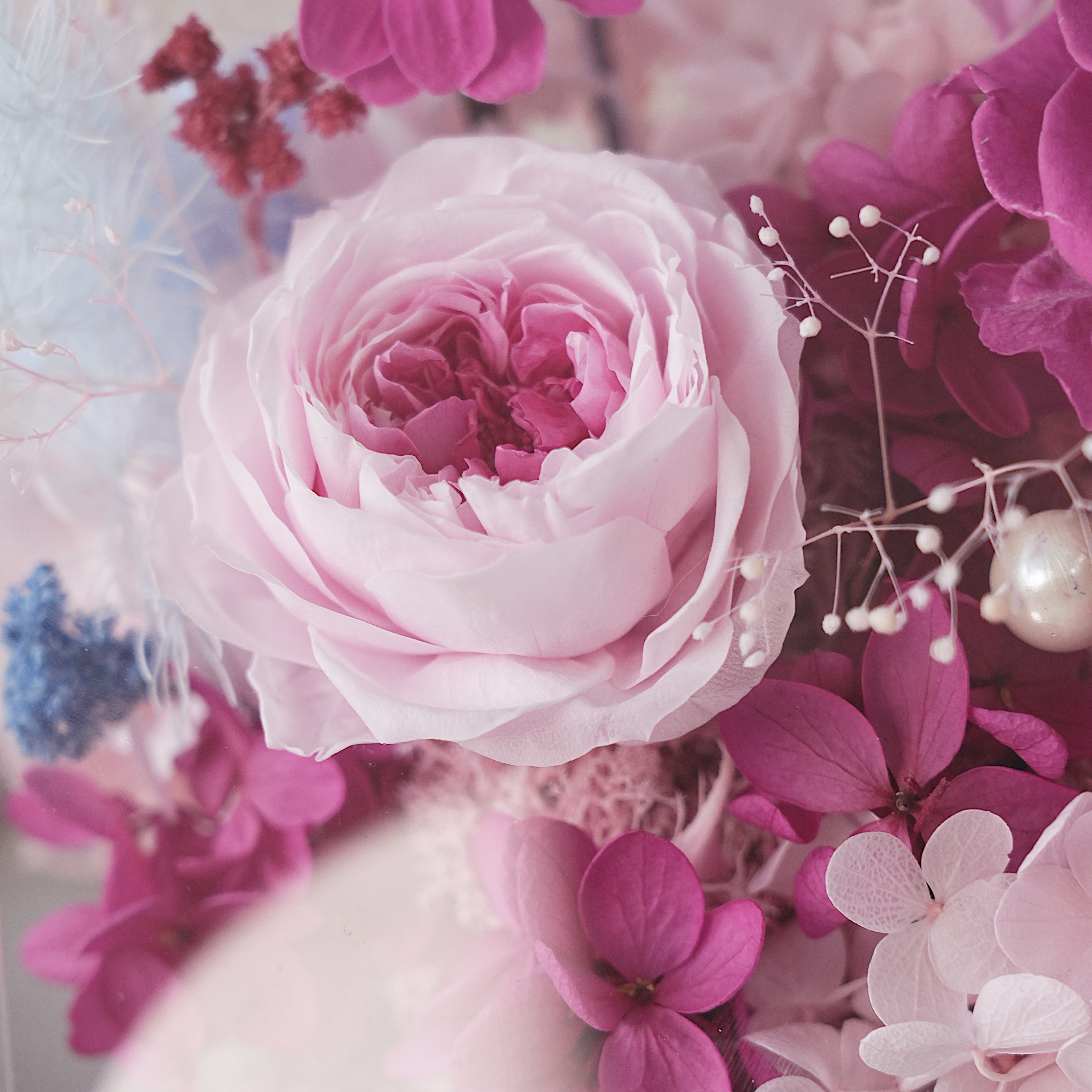 Pink rose and other flowers with a sentimental message on a card