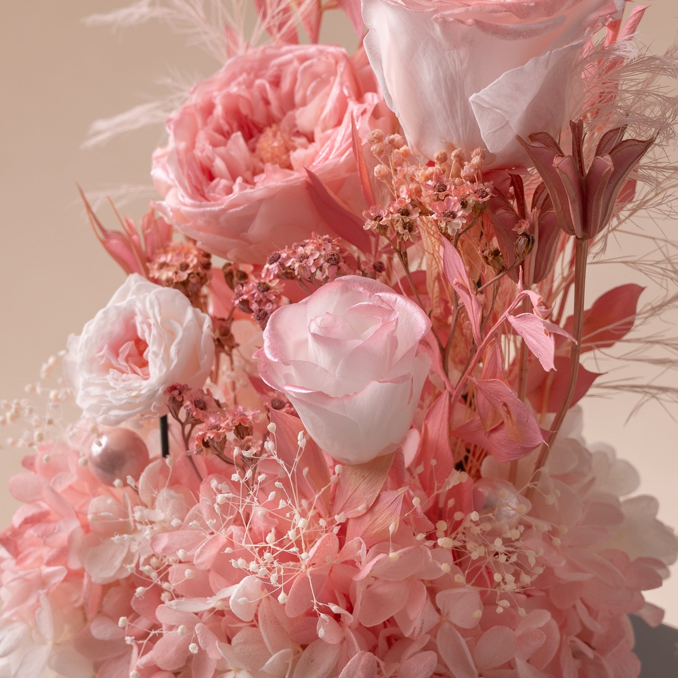 Delicate pink floral arrangement on a neutral background