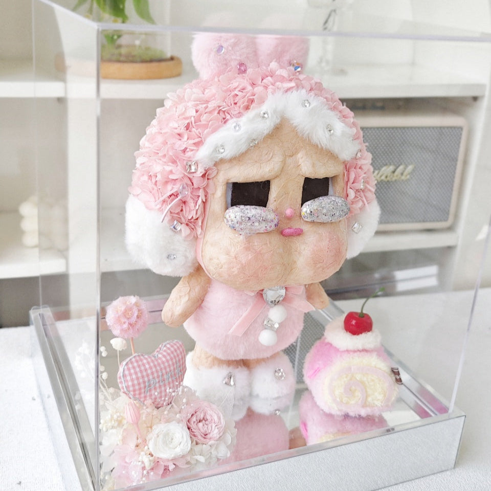 Flower Crybaby-I'll give you all my love with decorative elements in a clear box on a white surface.