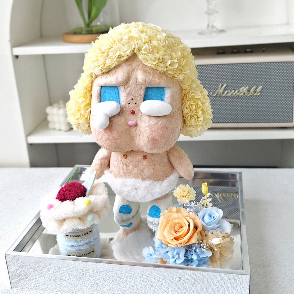 Flower Crybaby-baby blonde with blonde hair and blue eyes on a reflective surface with a blurred background