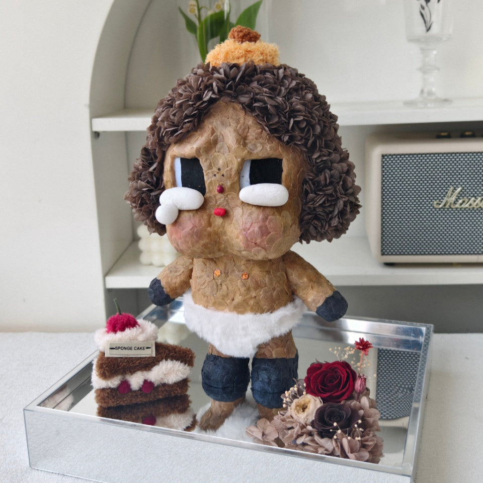 Flower Crybaby-baby brown with a cake and flowers on a reflective surface