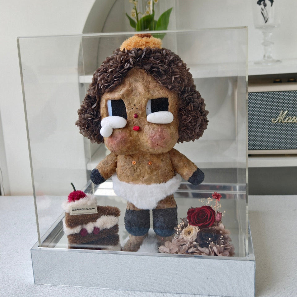 Flower Crybaby-baby brown with decorative elements in a clear display case.