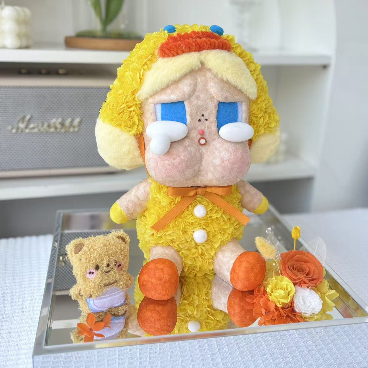 Flower Crybaby-duck you with yellow hair and orange outfit on a reflective surface