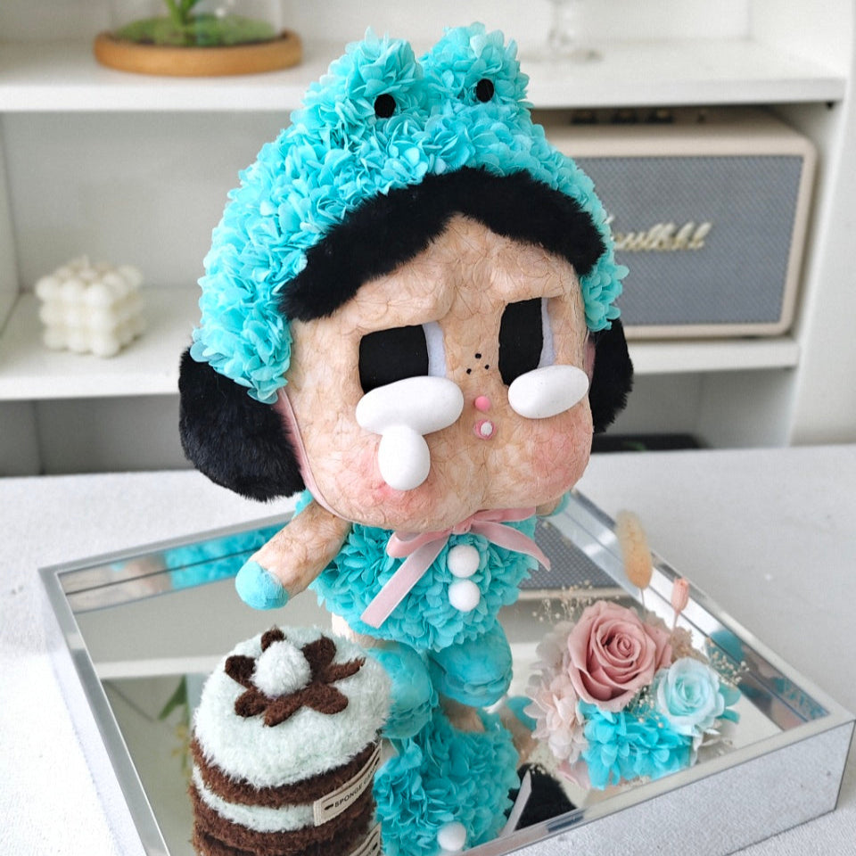 Flower Crybaby-what a frog with blue hair and black and white face on a mirrored surface