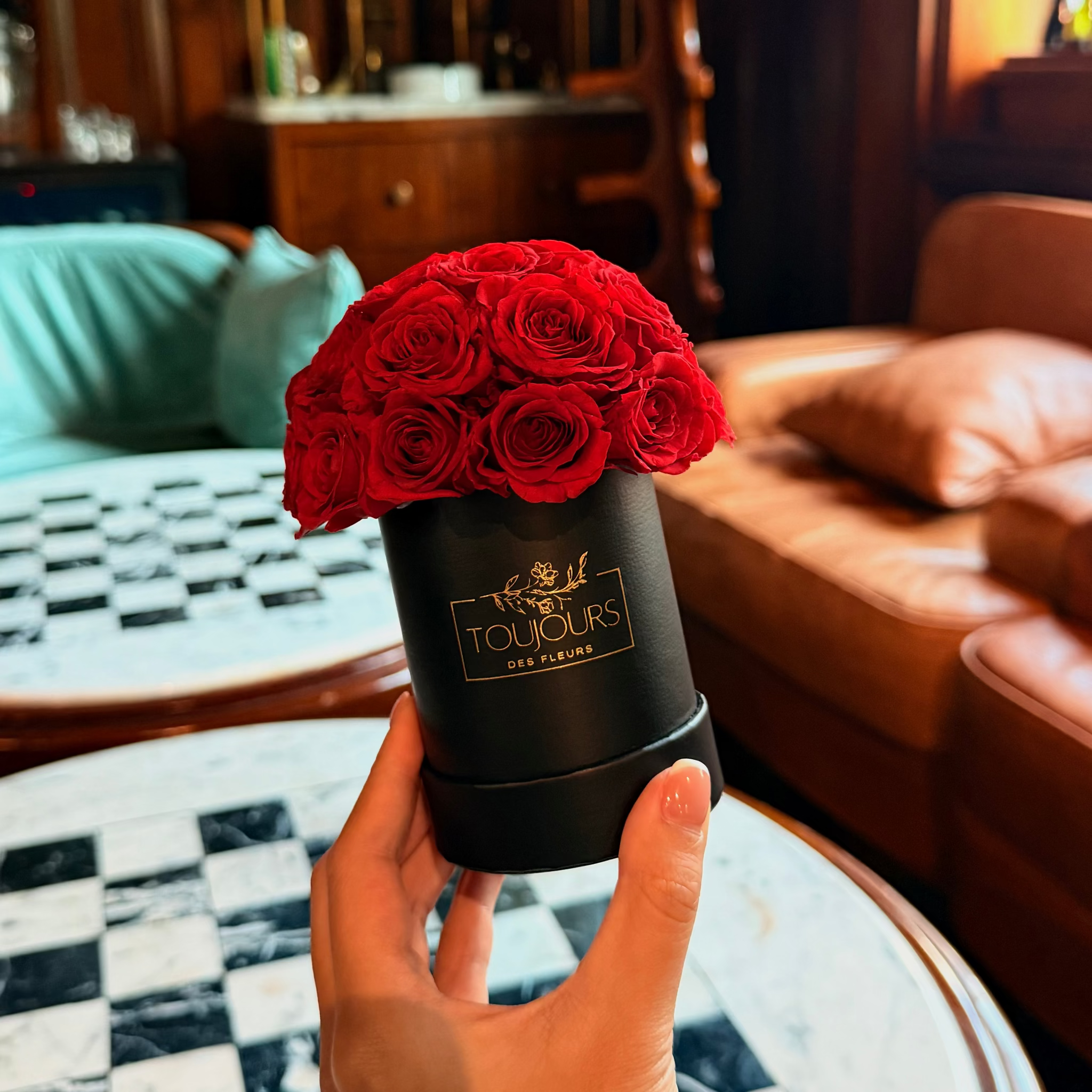 Black box with red roses on a marble surface