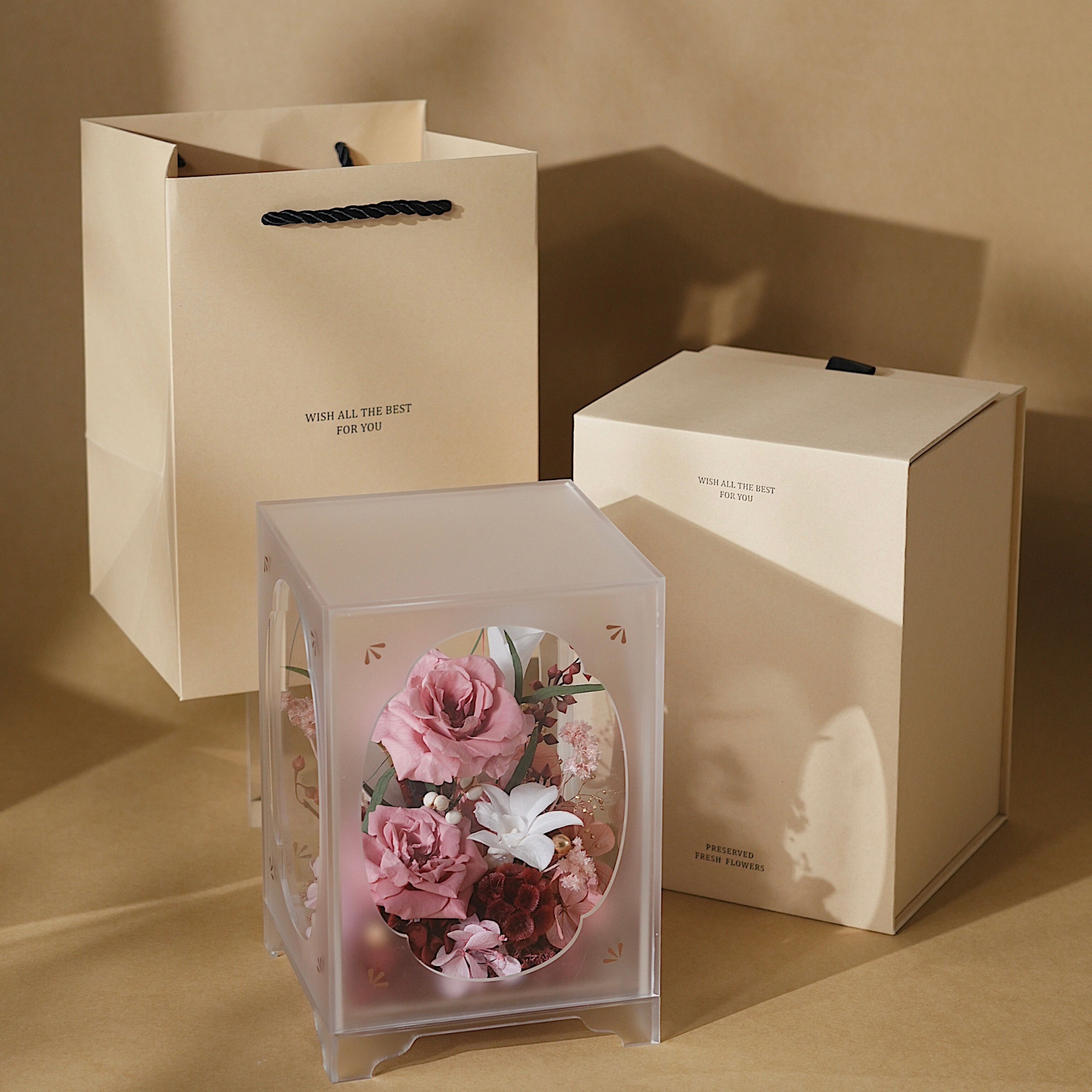 Transparent cube with preserved flowers on a wooden surface