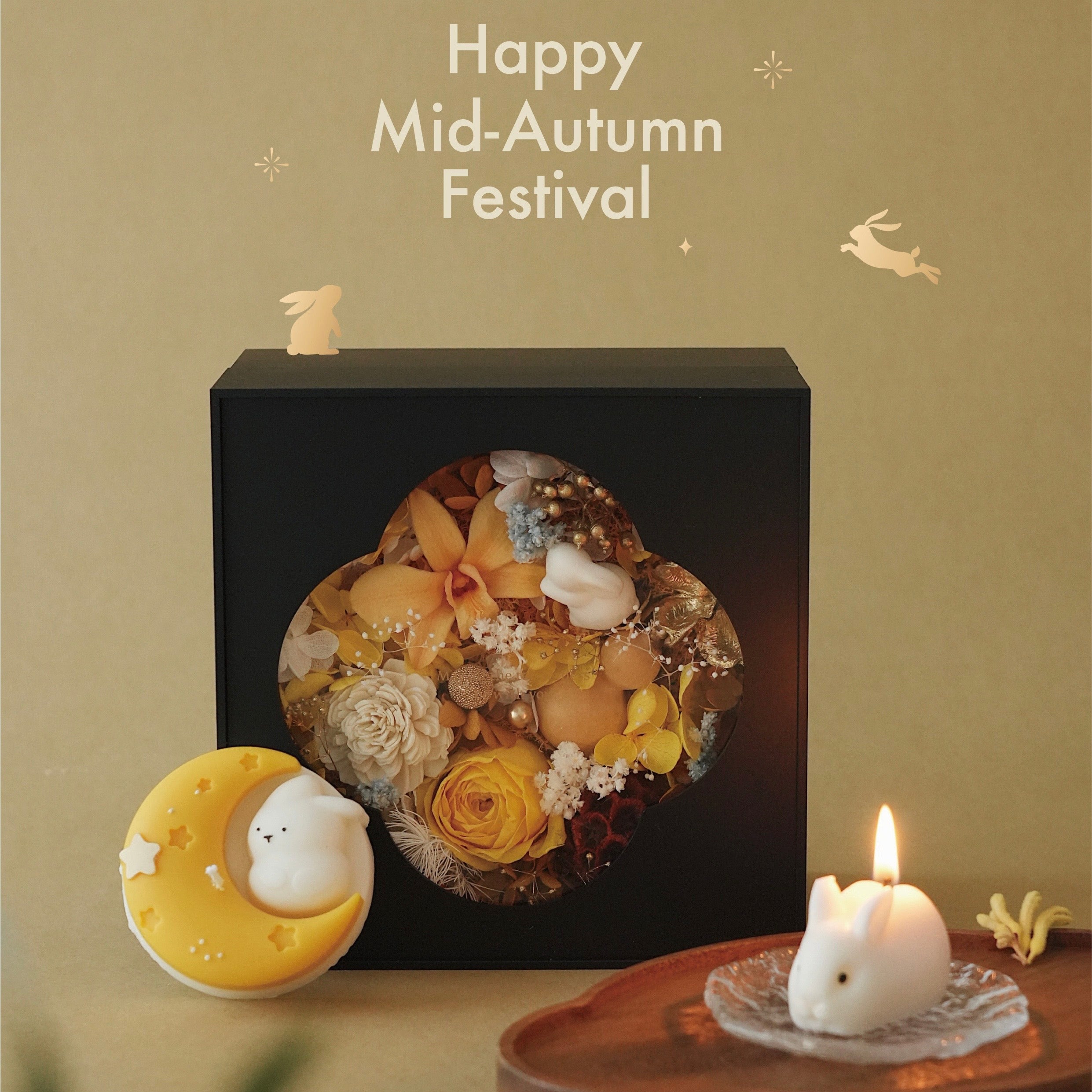 Decorative floral arrangement in a black box with 'Happy Mid-Autumn Festival' text on a beige background.