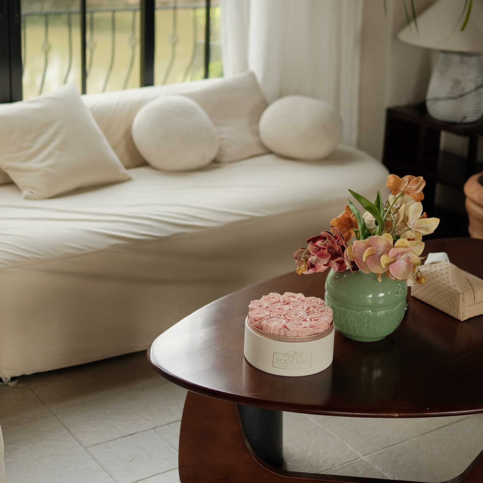 Living room with a beige sofa, wooden coffee table, and decorative items.