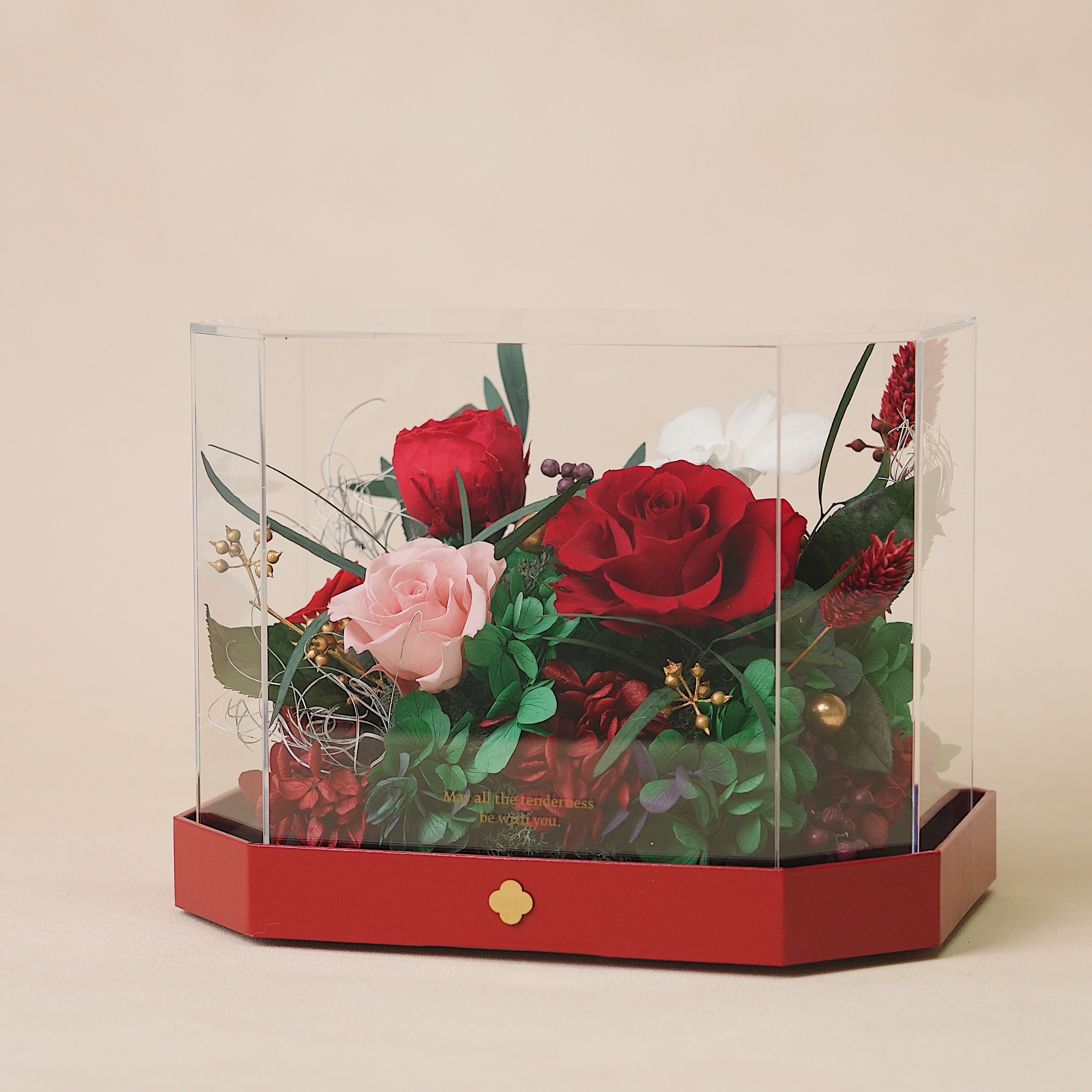 Hexagonal clear box with red roses and pink flowers on a beige background